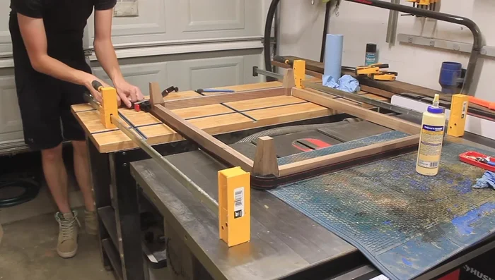 Assemble the leg and stretcher base, ensuring it nests within the dog bed box.