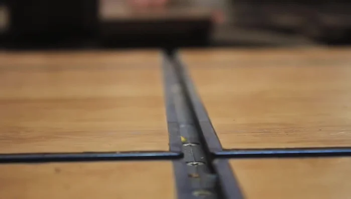 Drill recesses for brass plugs before assembly (if possible).