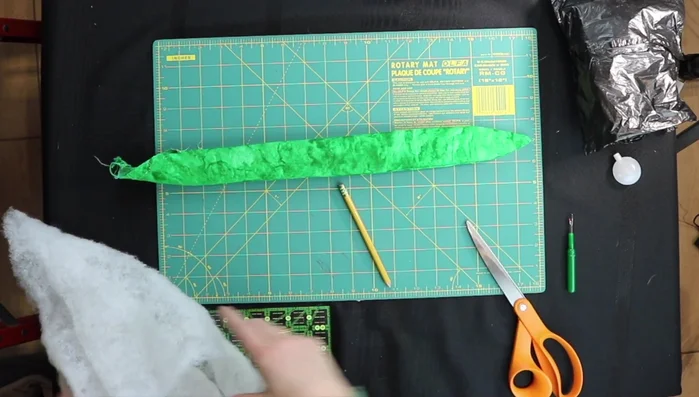 Stuff and add squeakers: Stuff the snake with batting, and insert squeakers at intervals. Use scissors to help push the stuffing and squeakers into place.