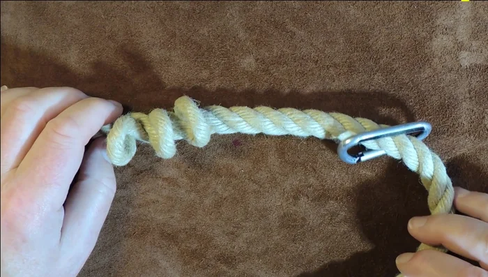 Attach the clip to one end of the rope and feed the rope through the three loops, creating a Cat's Paw eye splice. Tighten securely.