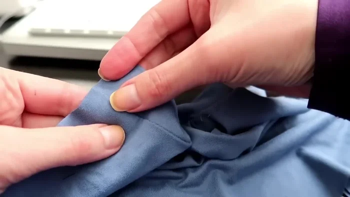 Topstitch armhole cuffing: Turn cuffing to the inside and topstitch next to the original seam with a zigzag stitch.
