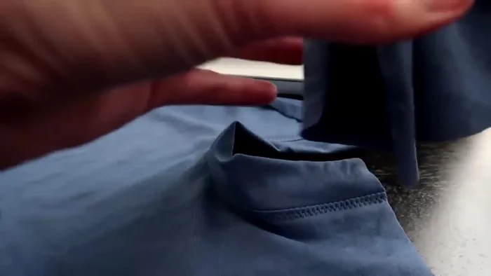 Attach belly piece: Pin the belly piece to the back piece, starting from the bottom and working up to the armholes, ensuring a slight gap at the armholes for the cat's movement. Sew with a zigzag stitch, and then serge or topstitch the seam allowance.