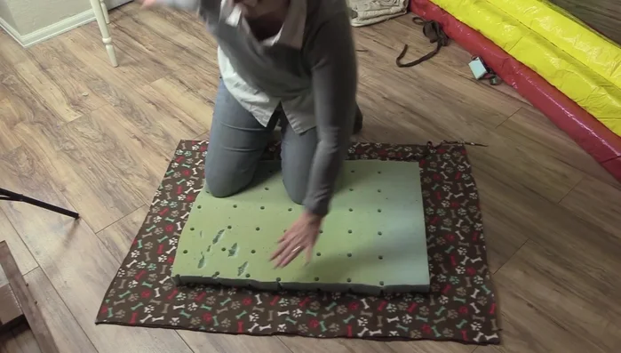 Tie the strips from the top and bottom fleece pieces together, creating a knot for each strip. Use scissors to make the strips thinner if needed for easier tying.