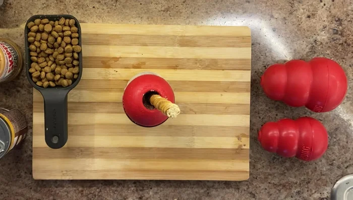 Bully Stick Kong: Fill the Kong two-thirds full and insert a bully stick through the middle.