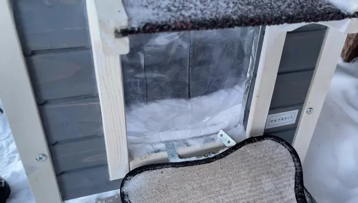 Add a clear vinyl layer as an additional door flap to reduce drafts.