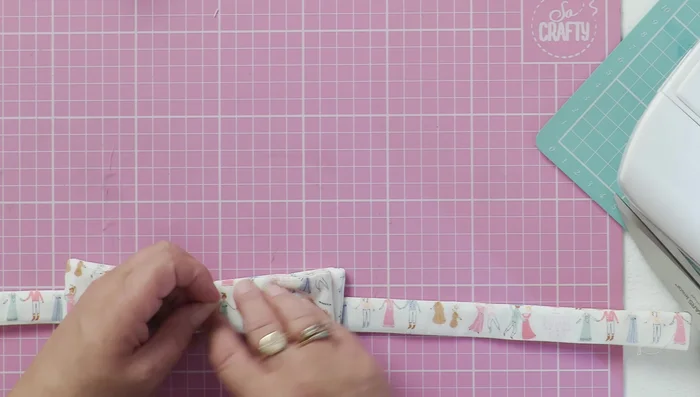 Stitch the back of the bow to the collar, ensuring it lays flat.