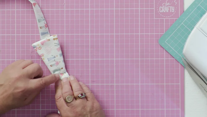 Stitch the back of the bow to the collar, ensuring it lays flat.