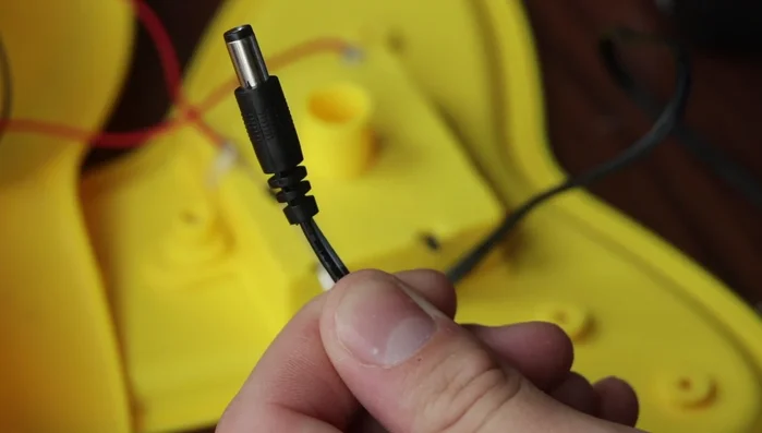 Prepare the cat toy for soldering and obtain the appropriate power adapter.