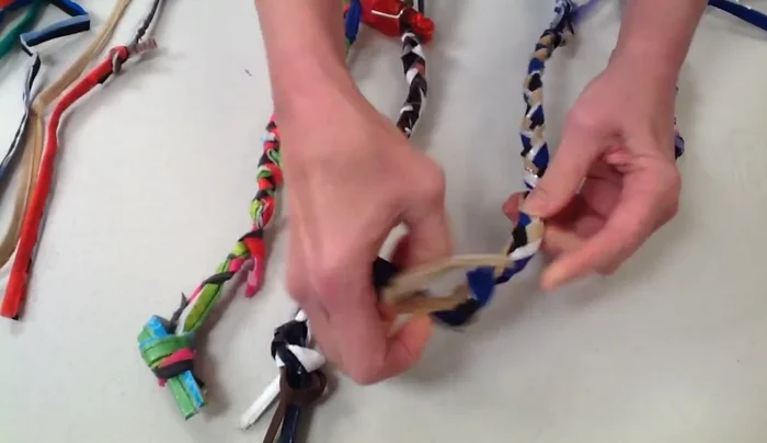 Braid the three braids together tightly. Tie another tight knot at the end. Trim any loose ends.