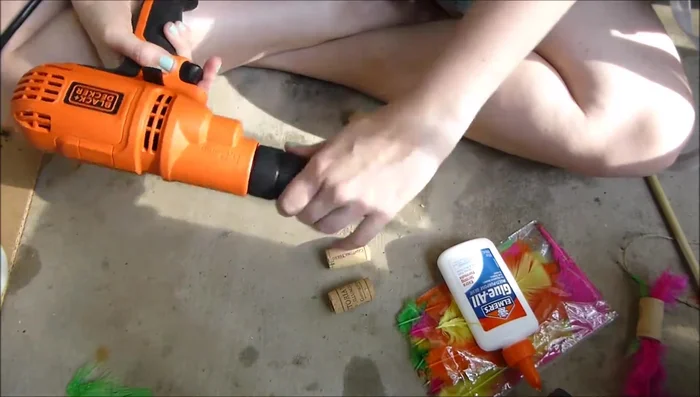 Insert feathers into the holes, ensuring glue isn't visible on the outside.