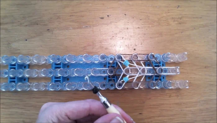 Create the nose and snout using dark brown and white bands.