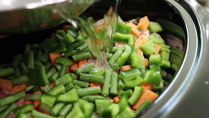 Cook on low for 24 hours (or simmer on the stove for 12 hours, or use an Instant Pot - although the speaker prefers the slow cooker method).