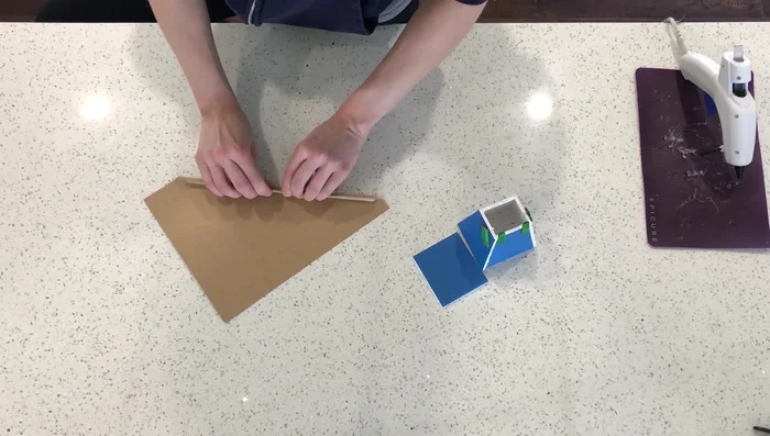 Create a small platform (approx. 3 inches x 3 inches) from popsicle sticks to hold treats. This piece should be just the right size to not fold over. 