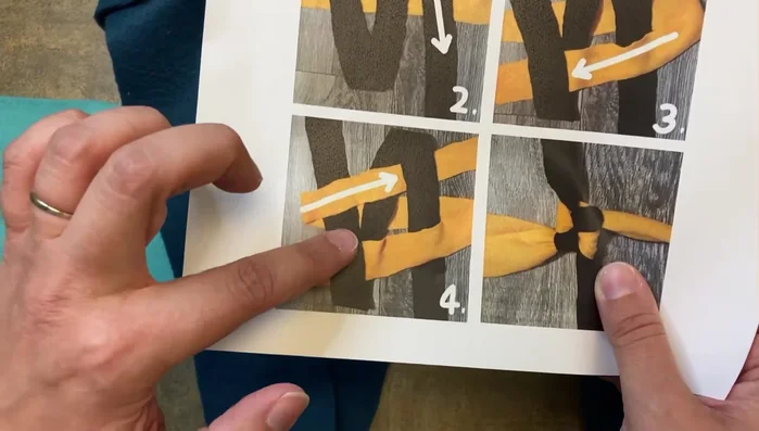 Take the leftmost piece of the horizontal fleece strip, pull it over the middle vertical piece, and then through the rightmost vertical piece to create a square knot.