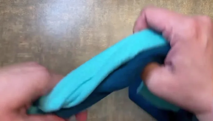 To finish, tie a knot at the end of the fleece strips, leaving extra length to secure the knot.