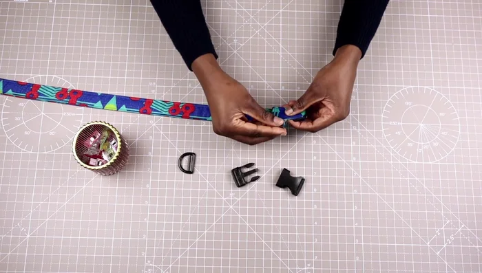 Secure and sew the triglide: Secure the triglide with clips and sew it down.