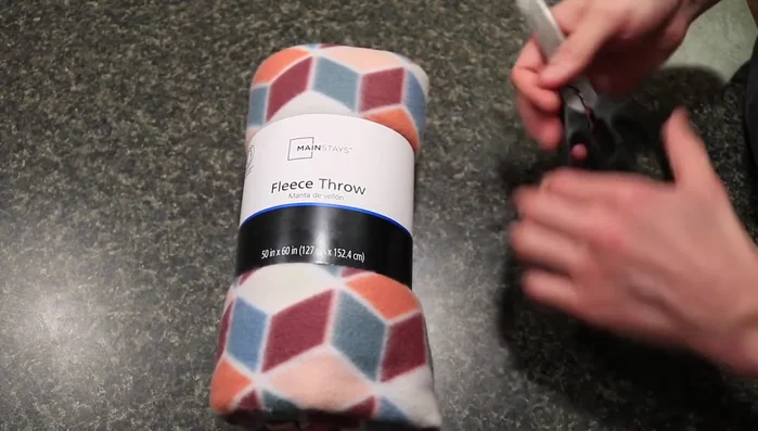 Prepare the fleece: If using a blanket, unfold it. If using fabric, lay it flat.