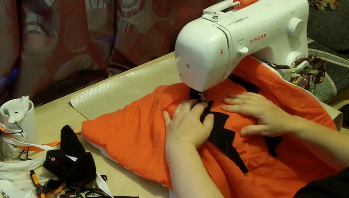 Add the pumpkin ridges: Sew vertical lines to create the pumpkin ridges. Use contrasting fabric or thread for a more dramatic effect.