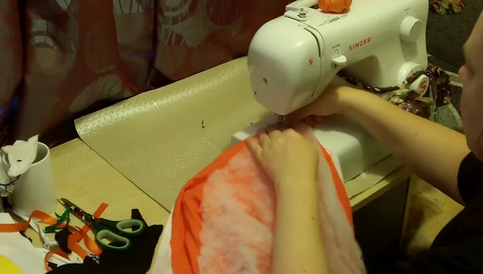 Cut a rectangle: The widest part (shoulders) determines the width. Divide the width in half, then divide that half into thirds. The length can be the child's height or a calculation based on a semi-circle (see video for specifics).