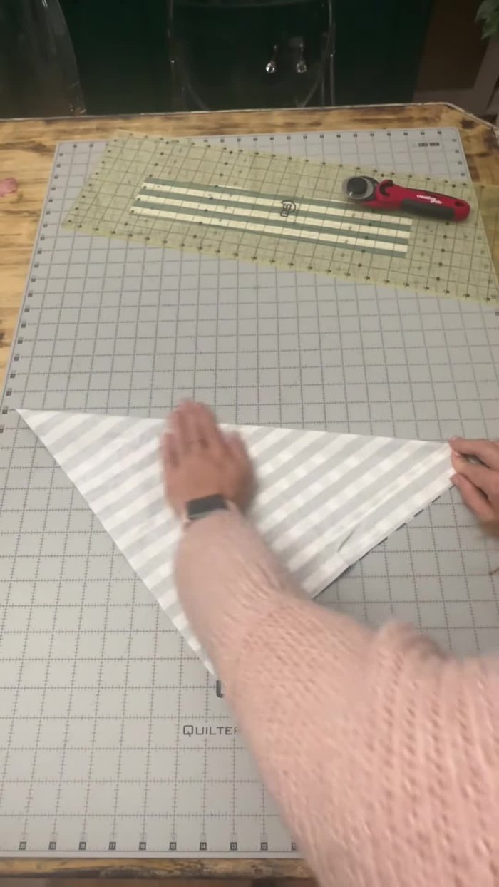 Fold the square in half to form a triangle, press with an iron.