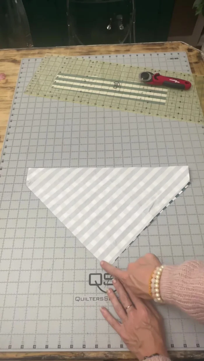 Fold the fabric in half again (right sides together), sew the bottom V-shape, and trim the excess with pinking shears.