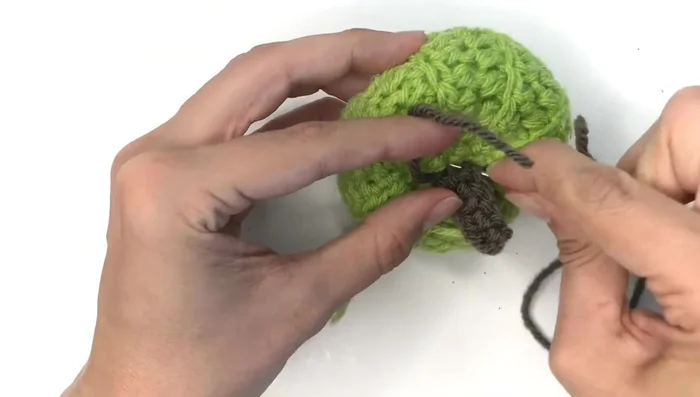 Sew the stem to the top of the pumpkin.