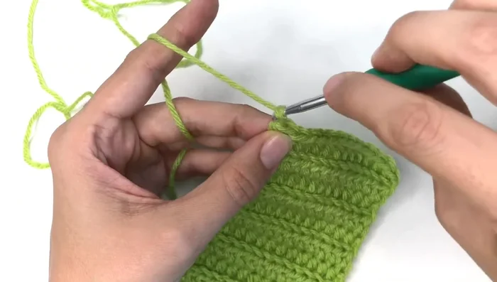 Turn the piece inside out. Use the tail to close the opening by sewing through both layers of fabric.