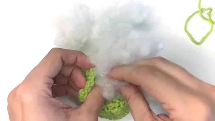 Stuff the pumpkin with poly-fiber fill, creating an indentation in the middle. Add catnip to the center.