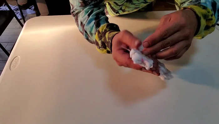 Tighten the fabric further using additional rubber bands to ensure a secure and well-defined cat butt shape.