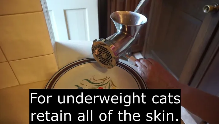 Grind meat and bones: Grind the cooked chicken meat and bones using a grinder.