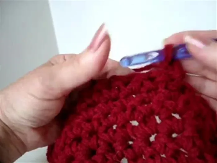 Once you reach the neck area, begin decreasing more aggressively to shape the hat. Skip every other stitch, single crocheting in the remaining stitches. Repeat this decreasing row one more time.