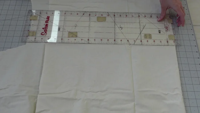 Cut and sew two rectangles for the crust, then fold and stitch to create a tube, and stitch lines to create pizza slices.