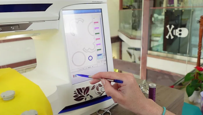 Arrange and sew on the embroidered pizza toppings using applique.