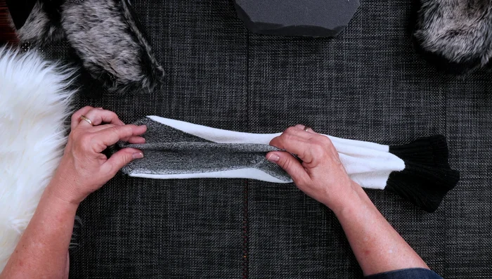 Decide which side of the sock fabric you want to show. Attach foam pieces to the inside of the sock to create the mouth.