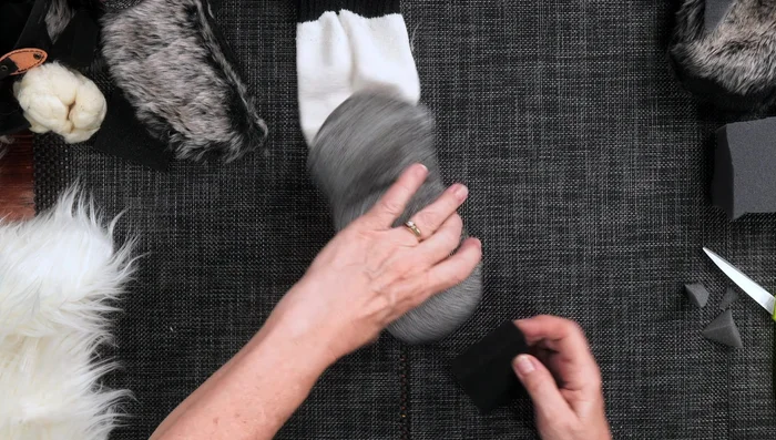 Create a tongue from felt, and glue it into place. 