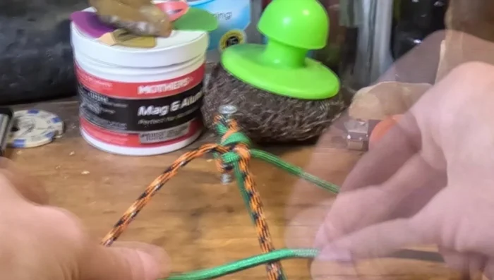 Continue the Cobra Weave: Repeat the weave until you reach the desired length. The instructor demonstrates the process.