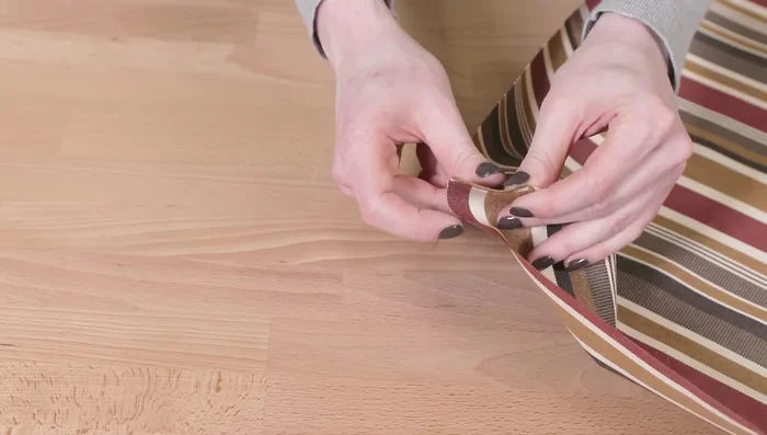 Sew along the edges of the velcro on the bottom piece. Fold the end in half an inch and sew on the velcro.