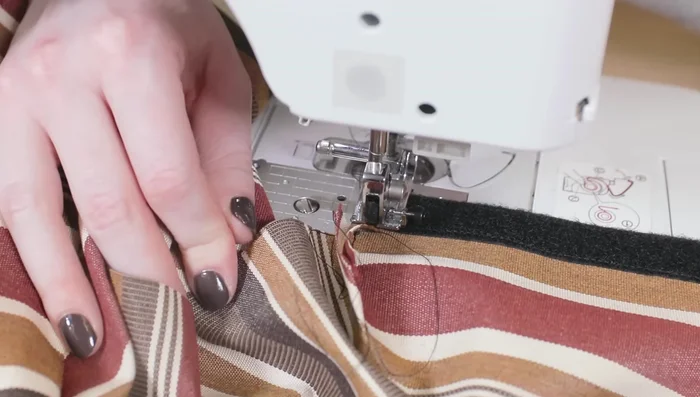 Sew along the edges of the velcro on the bottom piece. Fold the end in half an inch and sew on the velcro.