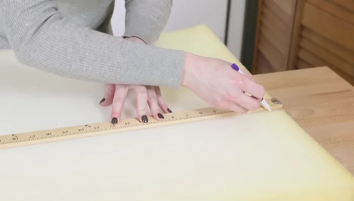 Cut the cushion underlining to be the width of the bed + 1 inch and the length of the bed + 1 1/2 inches.