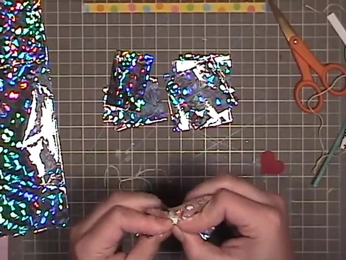 Pull the string tightly to secure the squares into a ball shape.