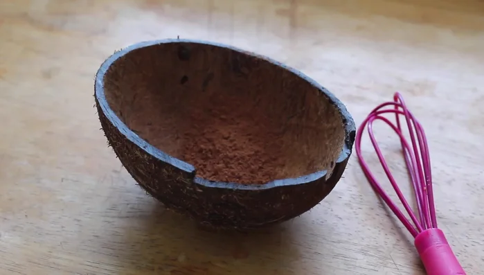 Add 2 tbsp unsweetened cacao or cocoa powder, 2 tbsp melted unrefined coconut oil, a pinch of sea salt, and your preferred sweetener (powdered sugar used in the video) to the cooled quinoa.