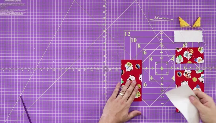 Attach ears to the face: Tack the ears to the top white portion of the cat's face with an 1/8 inch seam.