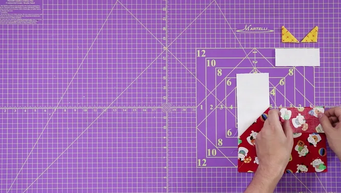 Attach ears to the face: Tack the ears to the top white portion of the cat's face with an 1/8 inch seam.