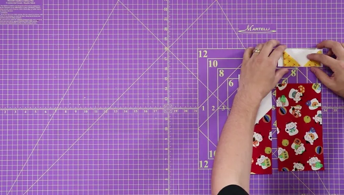 Attach ears to the face: Tack the ears to the top white portion of the cat's face with an 1/8 inch seam.