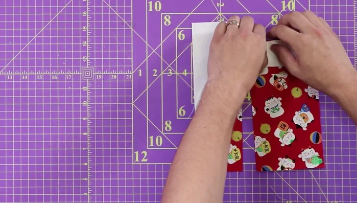 Sew the ear assembly to the main body: Sew the ear/face assembly to the main cat body using a 1/4 inch seam. Press seam open.